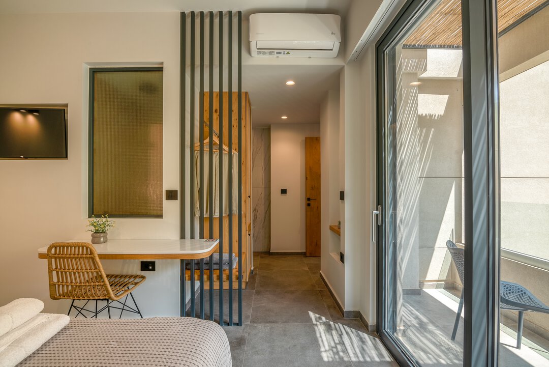 Designer bedroom with custom headboard, pendant lighting, and curated decor at Nusa Gramvousa, Crete