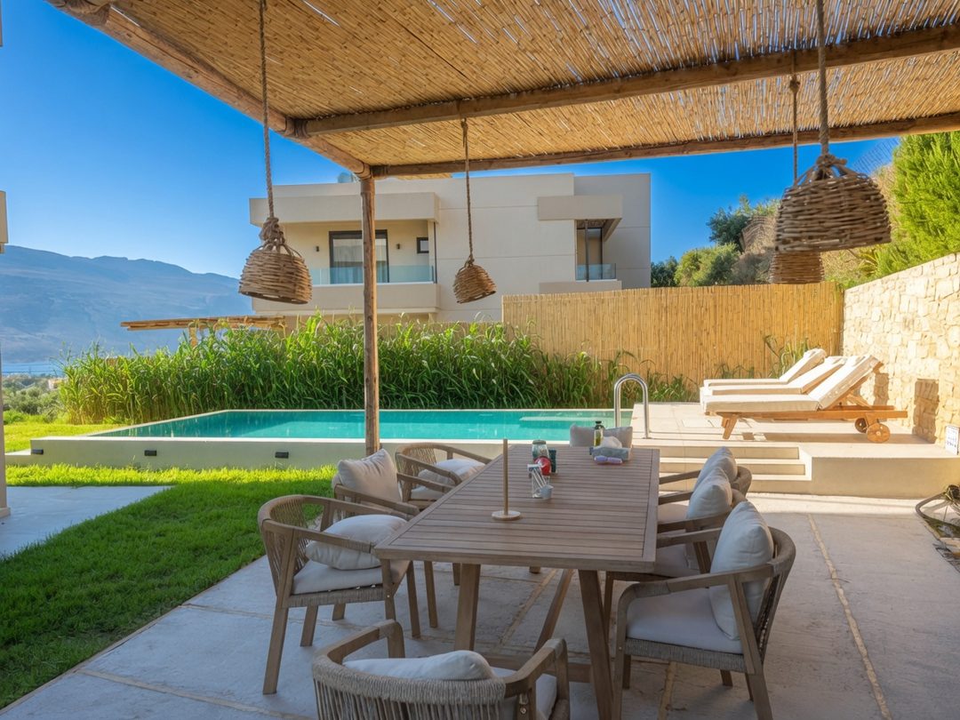 Covered patio dining area beside the pool at NUSA Balos